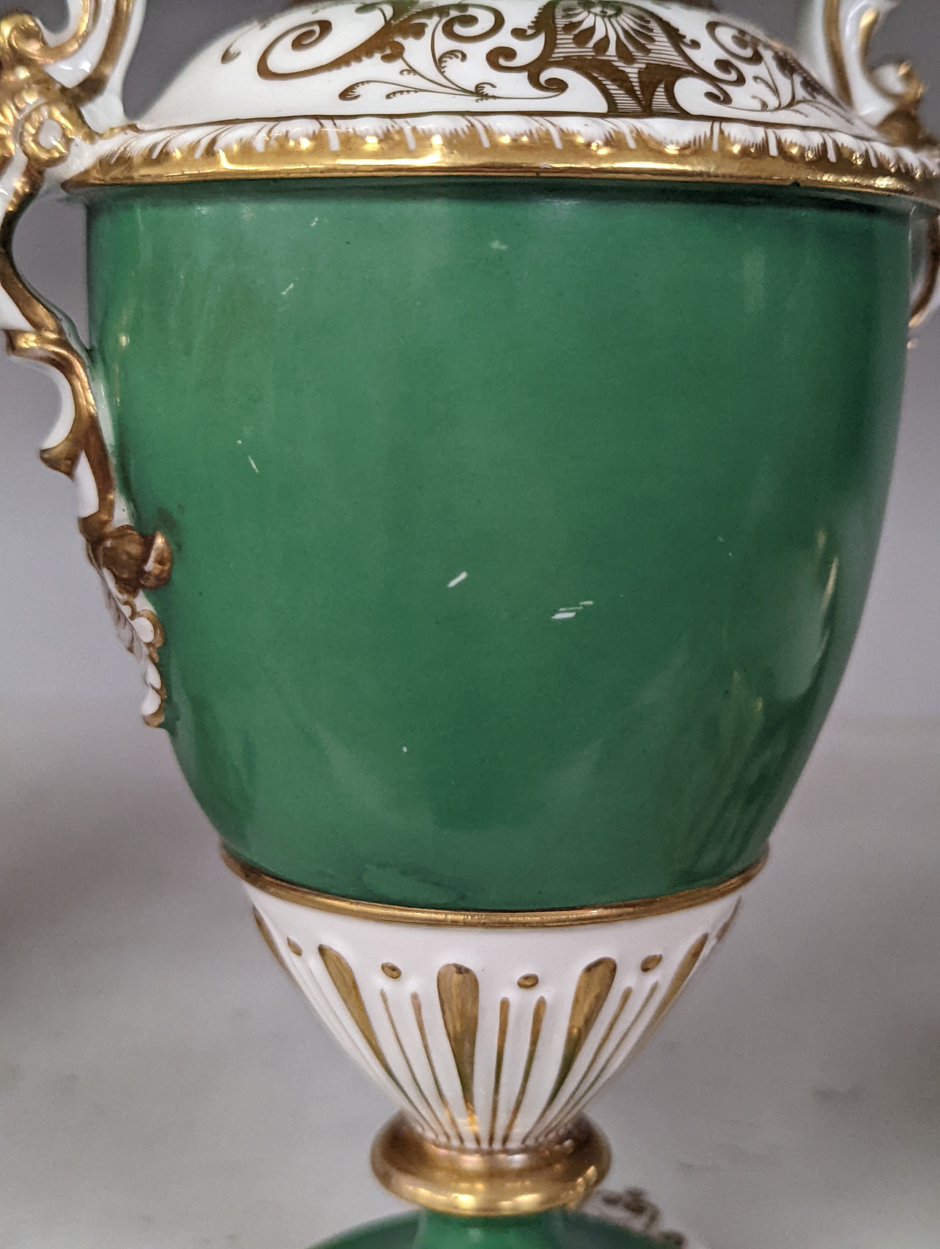 An English porcelain two handled vase painted with flowers in a panel on a green ground, probably Grainger Worcester, c.1830, height 24cm